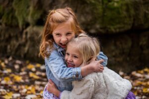 https://pixabay.com/photos/children-sisters-cute-girls-1869265/ Two little girls hugging and smiling 