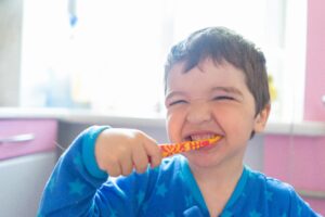Photo by Atlantic Ambience: https://www.pexels.com/photo/close-up-photo-of-boy-brushing-his-teeth-4185330/ young boy brushing his teeth happily 
